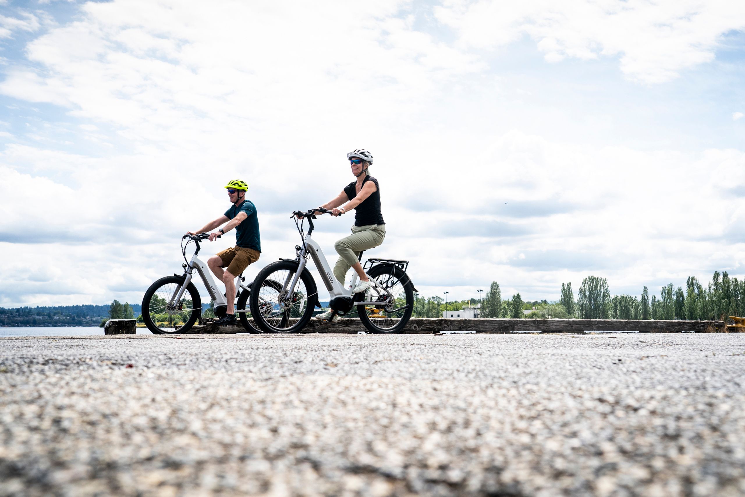 A couple enjoying a sunny day on electric bikes in Seattle, WA.